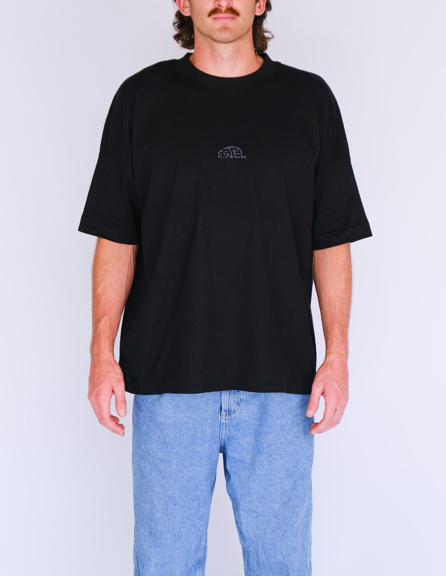 Model 1 wearing Box fit Black tee